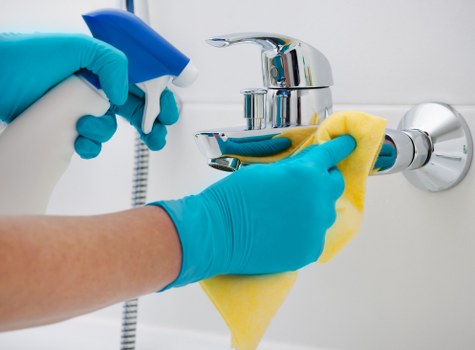 Cleaning specialist treating a carpet stain in a Kingston property